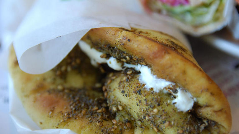 Manousheh is filled with zaatar and often a spoonful of labneh, which is similar to Greek yogurt. // © 2017 Creative Commons User avlxyz