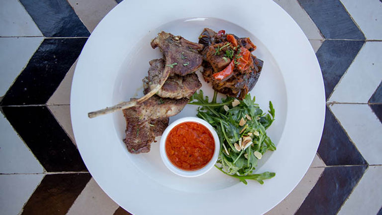 Nomad serves modern Moroccan fare, ranging from lamb chops served with spiced tomatoes, ratatouille and harissa (pictured) to more traditional tagines and mezze plates. // © 2018 Nomad