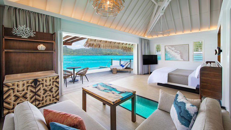 Overwater bungalows are spacious and modern, featuring the largest glass floor panels on the island.
