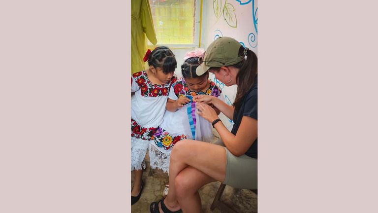 The author learning how to stich at the Lol-Chuy artisan cooperative in X-Pichil, Mexico