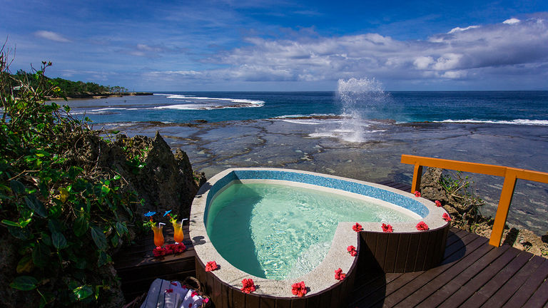 The resort features a cliffside, heart-shaped hot tub.