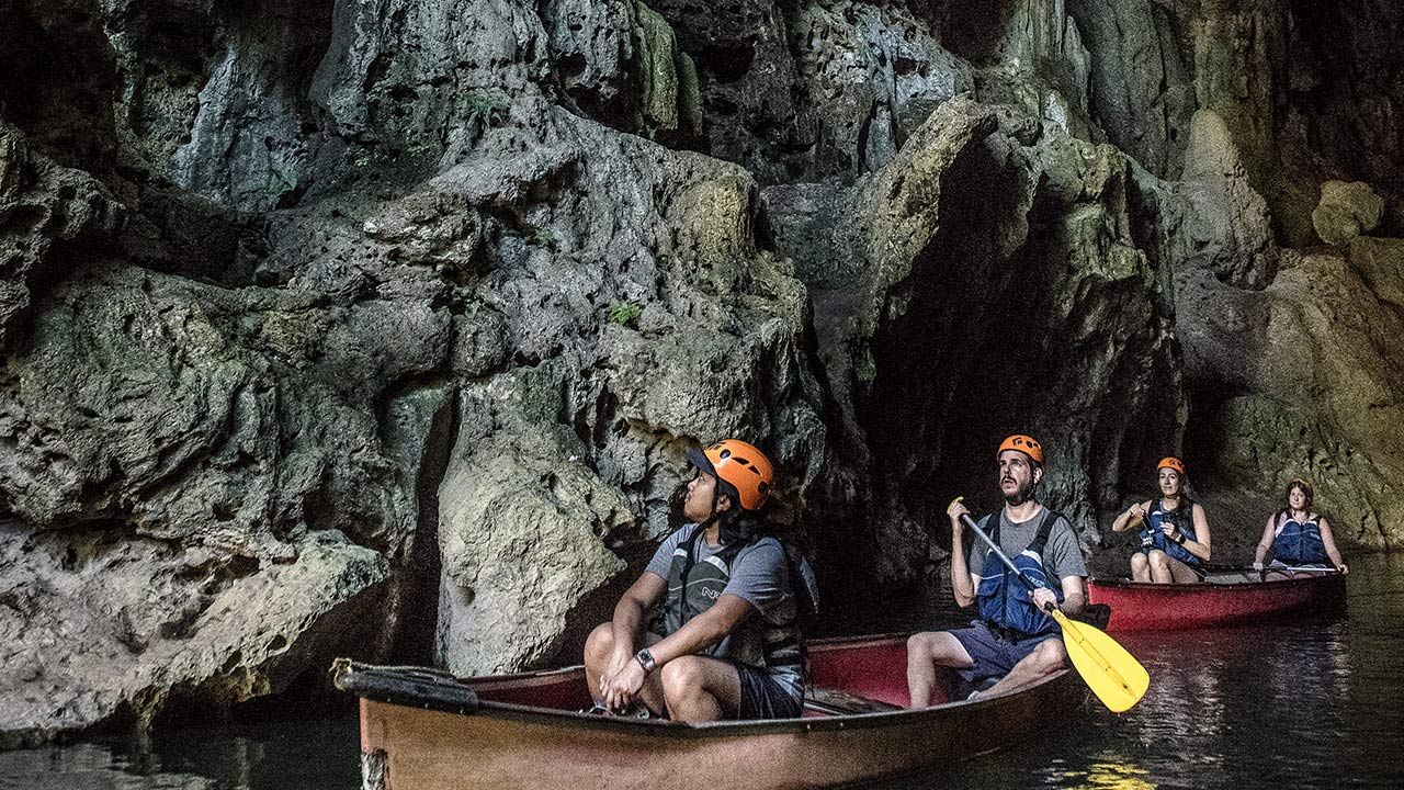 Travelers can take a day trip to explore ancient caves in Belize.